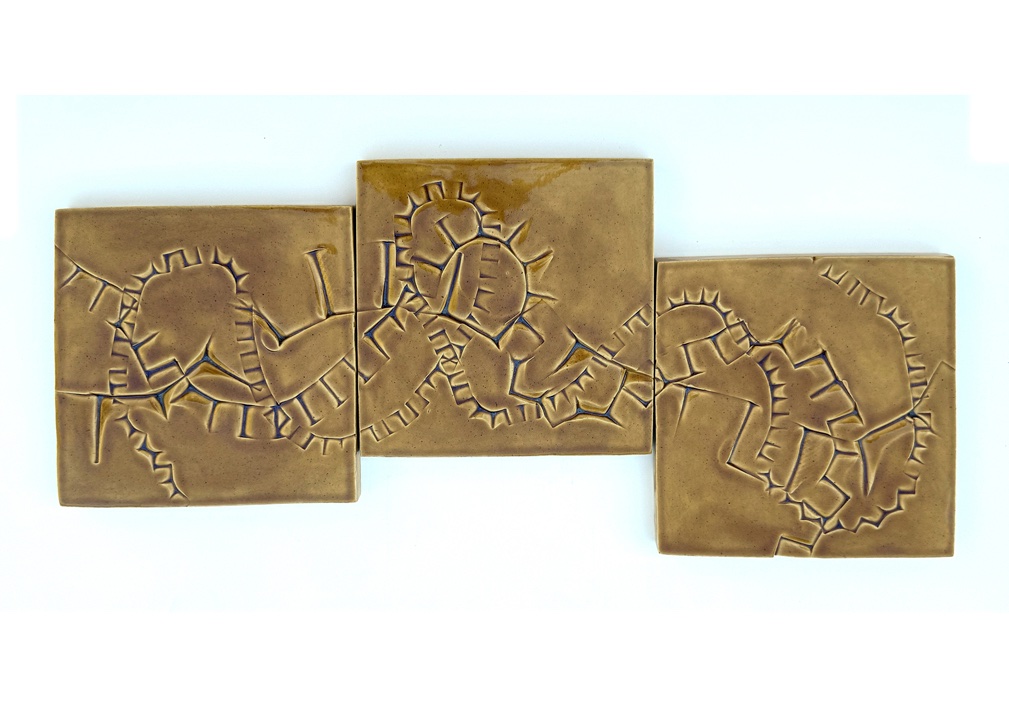Ceramic sculpture Consisting of three thick tiles with impressions made by cubes.