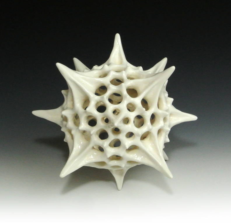 Ceramic sculpture of a biological polyhedral form, first view.