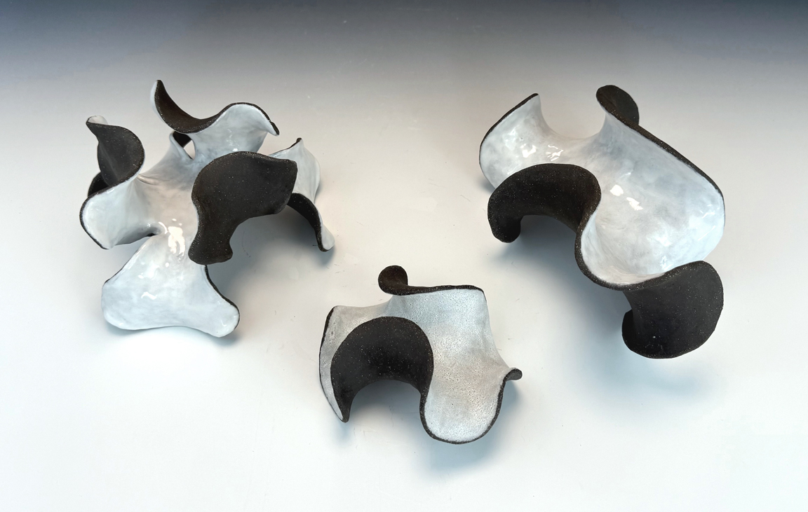 Three small abstract ceramic sculptures.